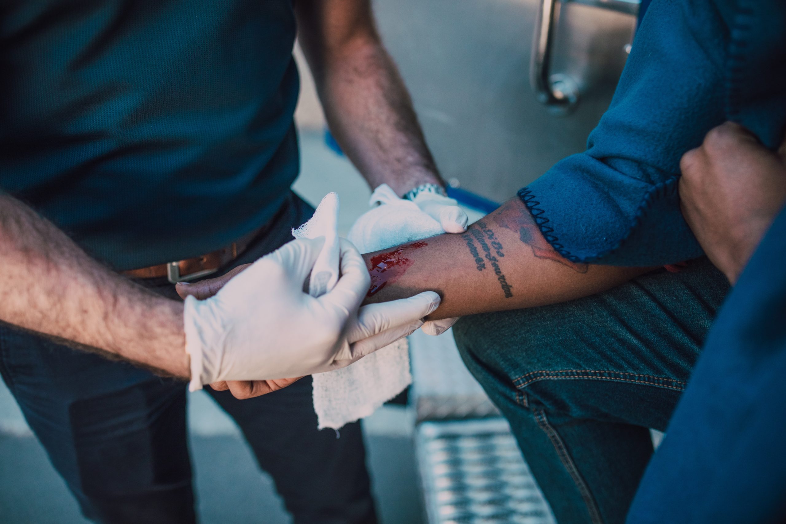 medical professional wrapping another person's arm injury
