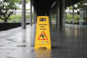 wet floor with yellow caution wet floor sign