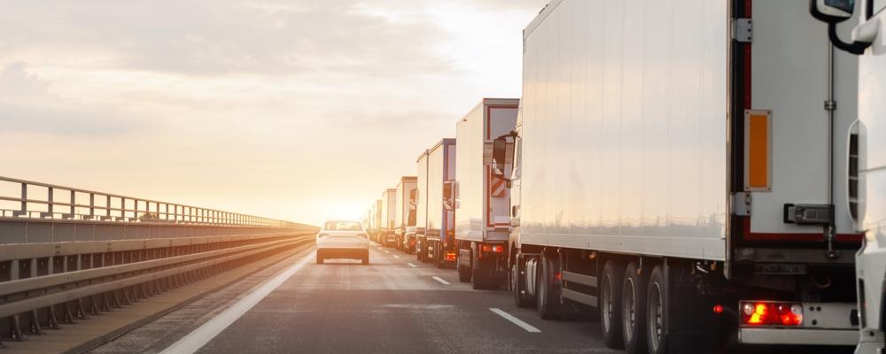 Queue of Trucks on Ukraine-Poland Border traffic jam at Sunset During Protest Roadblock.