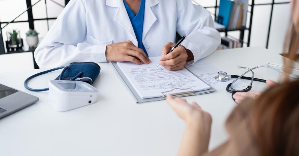 Healthcare. Doctor and patient are discussing interview consulting patient.