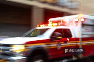A blurred ambulance races through the bustling streets of New York City, a beacon of hope and help in times of need.