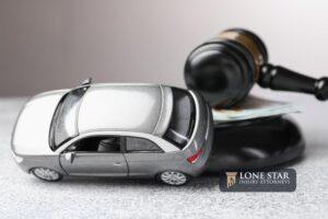 Motor vehicle accident law. Gavel, money and car model on grey background, closeup
