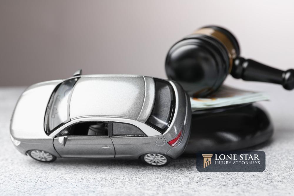 Motor vehicle accident law. Gavel, money and car model on grey background, closeup