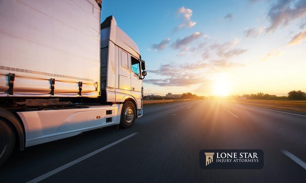 European truck driving on the asphalt road in rural landscape at sunset. Transportation and cargo concept.